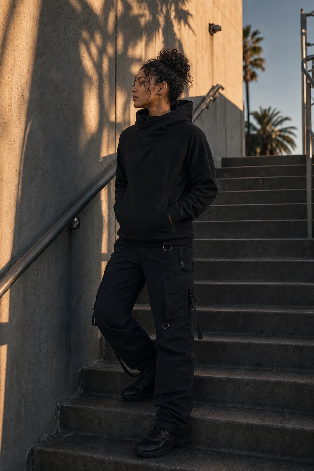 Editorial Los Angeles stairwell styling image showing a model wearing the Clothixpack CXP-H102 Signal Technical Hoodie.