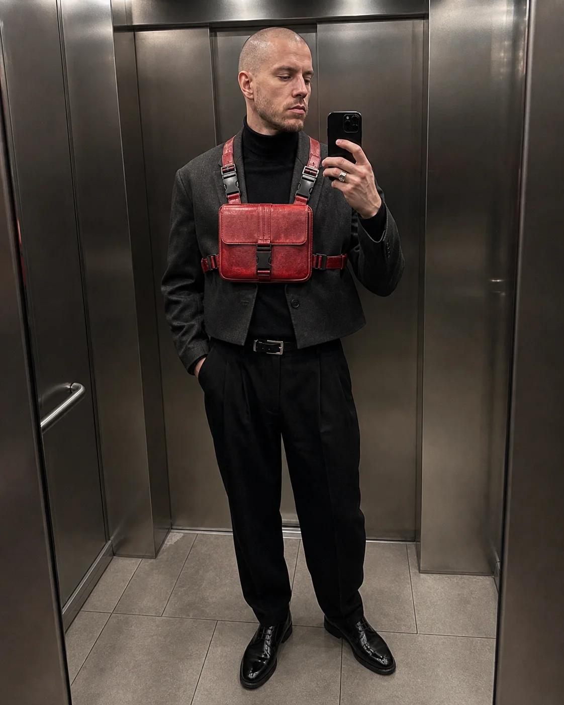 Paris elevator mirror styling image showing the Clothixpack CXP-A103 Null Chest Rig over black tailoring.